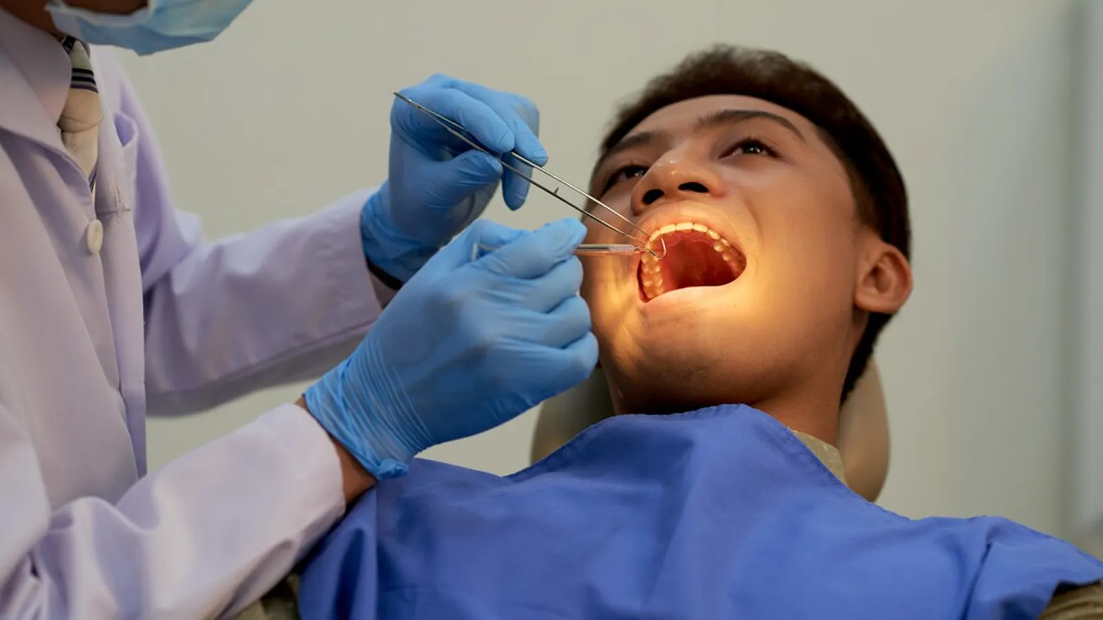 Patient in dental chair during teeth extraction consultation