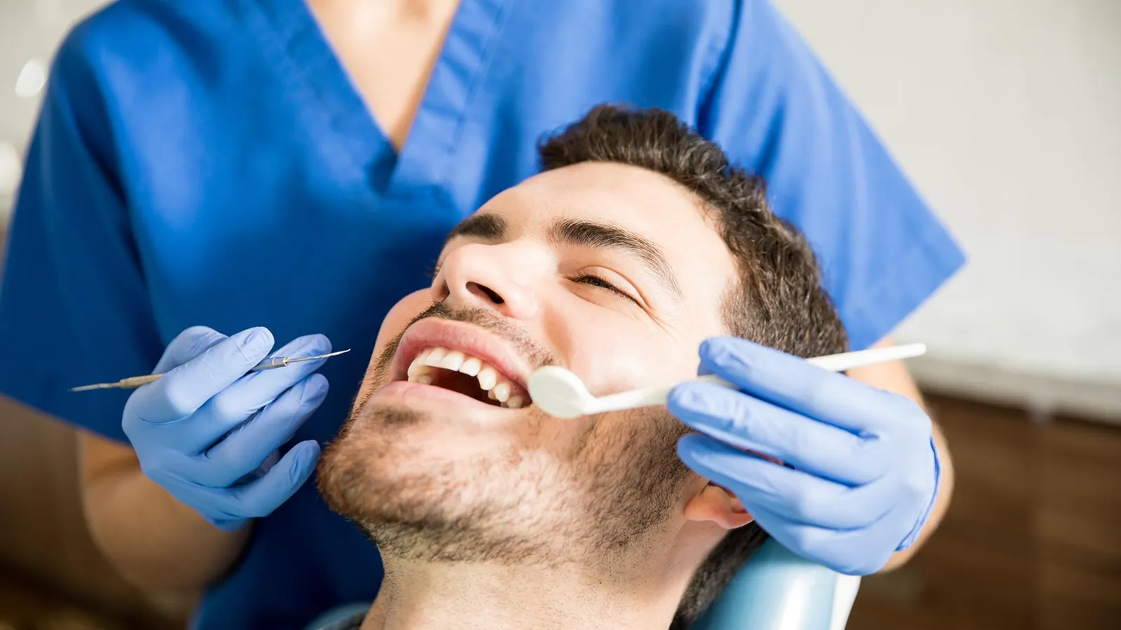 Patient in dental chair during teeth extraction consultation