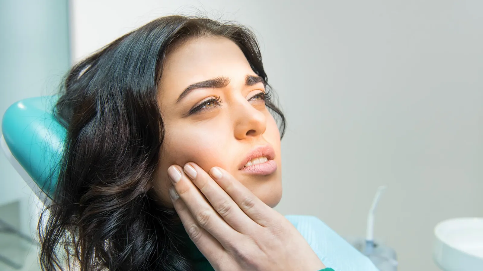 Patient in dental chair during teeth extraction consultation